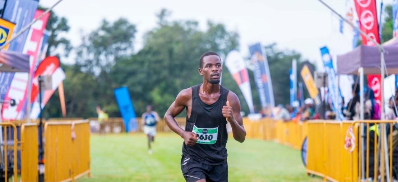 A runner approaching the finish at a road race in Zambia
